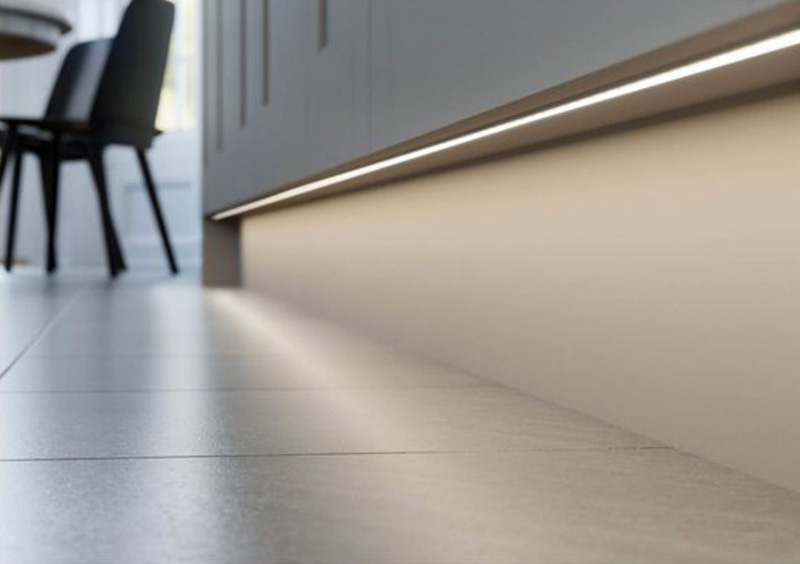 The slim LED channels installed under cabinets for skirting lighting